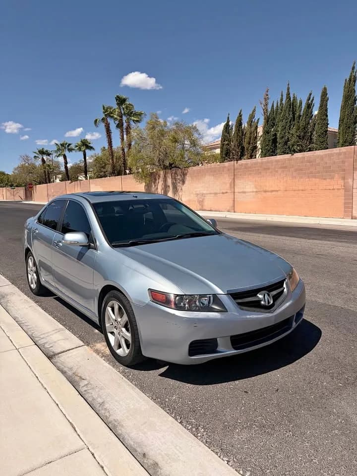 Silver Acura TSX sedan bought by Cash For Cars Nevada, parked at a residential curb