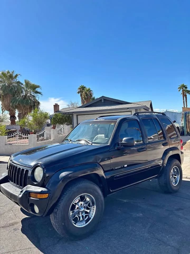 Black Jeep Liberty SUV bought by Cash For Cars Nevada, parked outside a seller's home