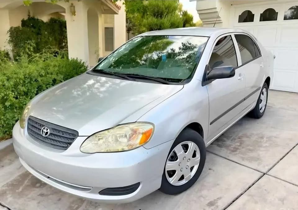 Silver Toyota Corolla sedan bought by Cash For Cars Nevada, parked in a home driveway
