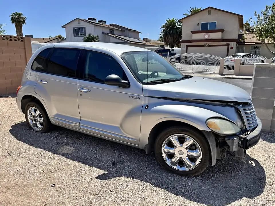 Silver 2002 Chrysler PT Cruiser Touring Edition with front-end damage, a junk car sold for cash in Las Vegas for $600