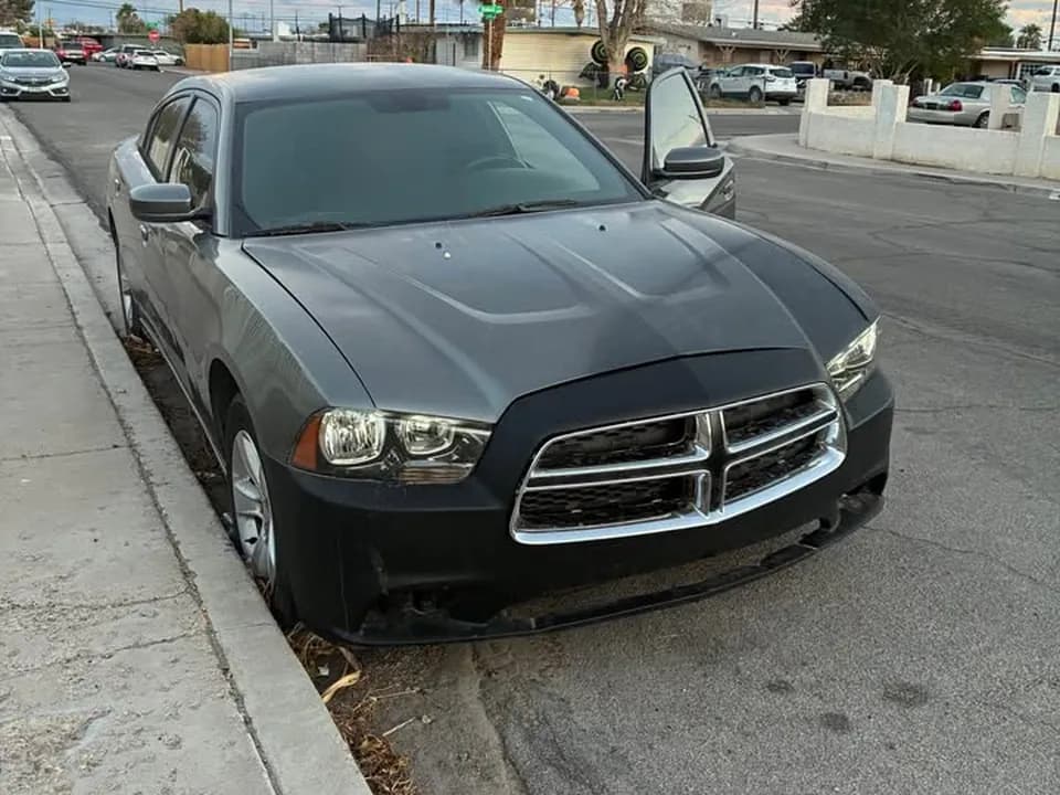 Gray 2011 Dodge Charger R/T sedan parked at a Las Vegas curb, sold for cash to Cash For Cars Nevada for $1,500