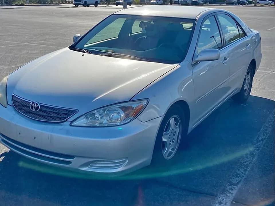 Silver Toyota Camry sedan in a Las Vegas parking lot, sold for cash to Cash For Cars Nevada for $2,500