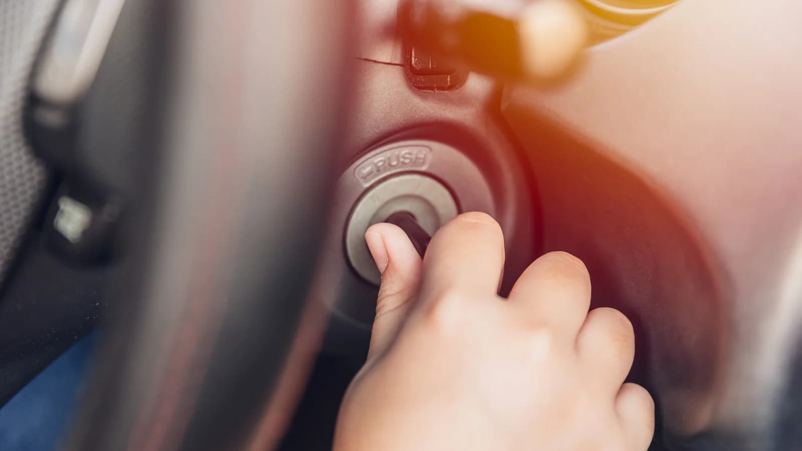 A hand turning the ignition key of a car that won't start: sell a non-running car in Las Vegas or fix it