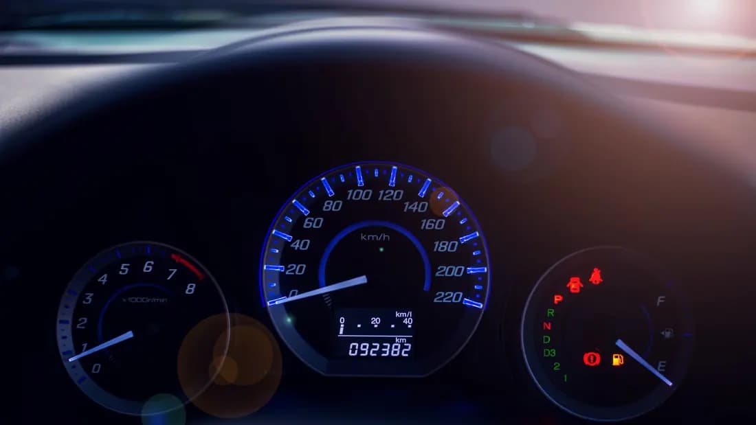 Close-up of a car instrument cluster showing the odometer reading