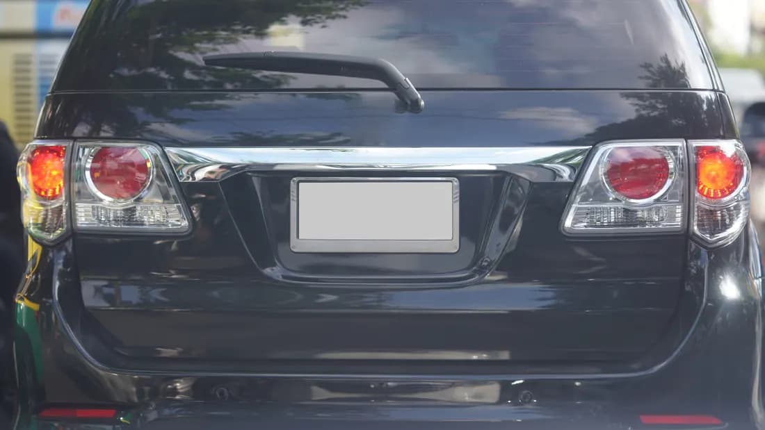 The rear license plate on the back of a dark SUV: you keep your license plates when you sell a car in Nevada