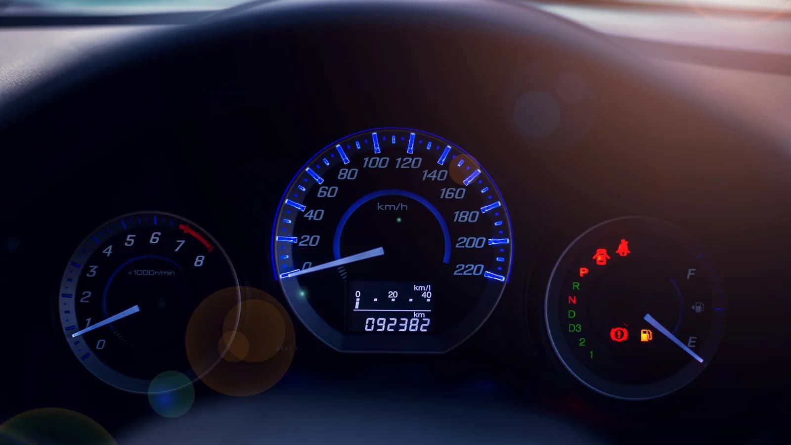 A lit car dashboard with the odometer showing high mileage: selling an old high-mileage car in Las Vegas