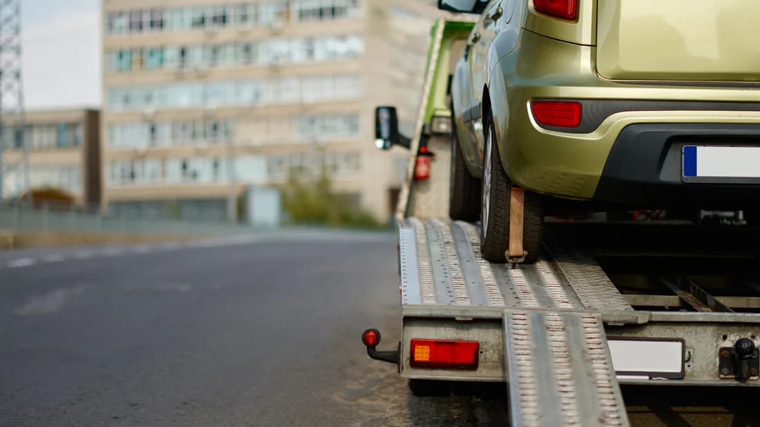 A car loaded on a flatbed tow truck: towing an abandoned vehicle from private property in Nevada