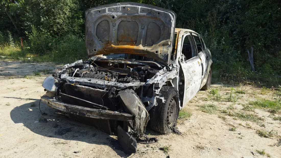 A fire damaged car with a burned engine bay A burned car with its hood open and the engine bay charred: a fire damaged car that may be nonrepairable in Nevada