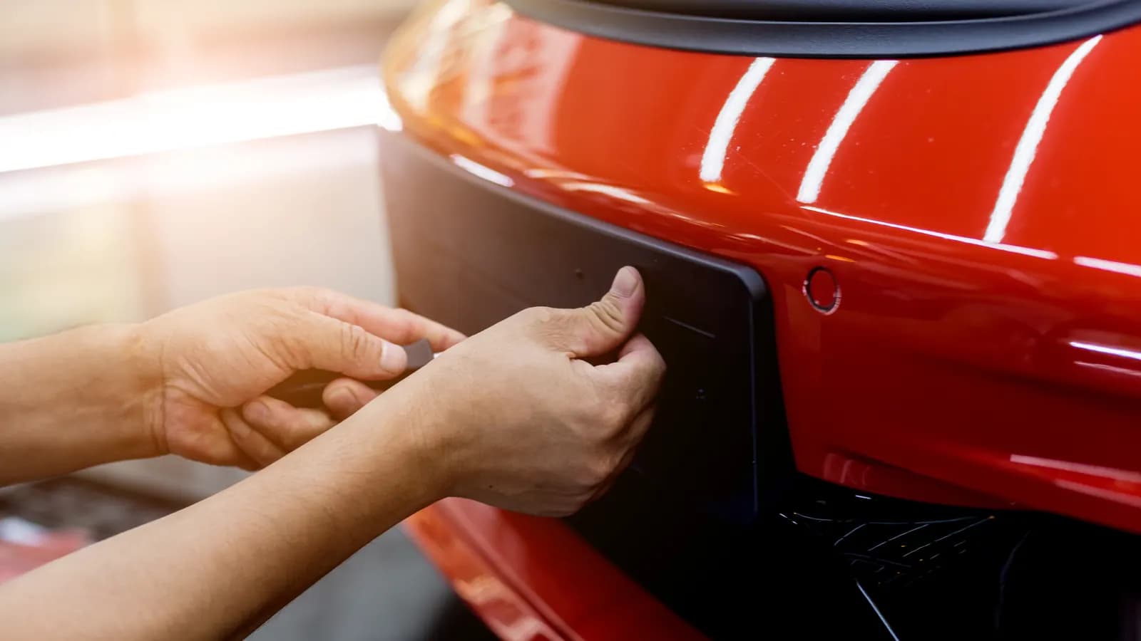 Taking the license plate off a car Hands removing a license plate from the back of a car: what to do with your license plates after selling a car in Nevada