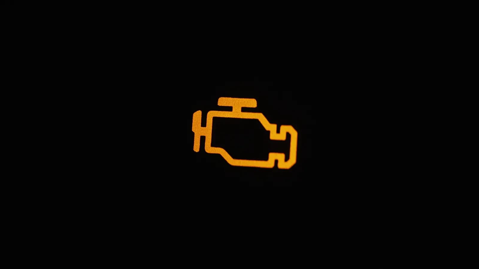 A check engine light glowing on the dashboard An illuminated check engine light on a car dashboard: selling a car with the check engine light on in Nevada